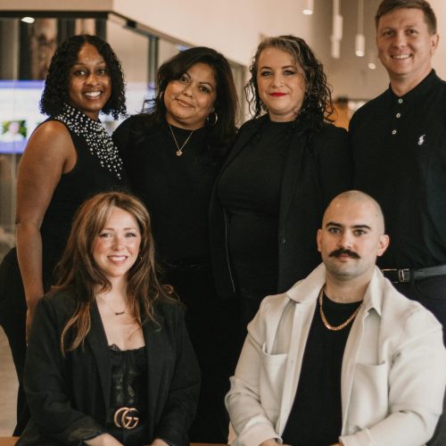 A diverse group of business professionals pose confidently in a modern office setting in Greenville.